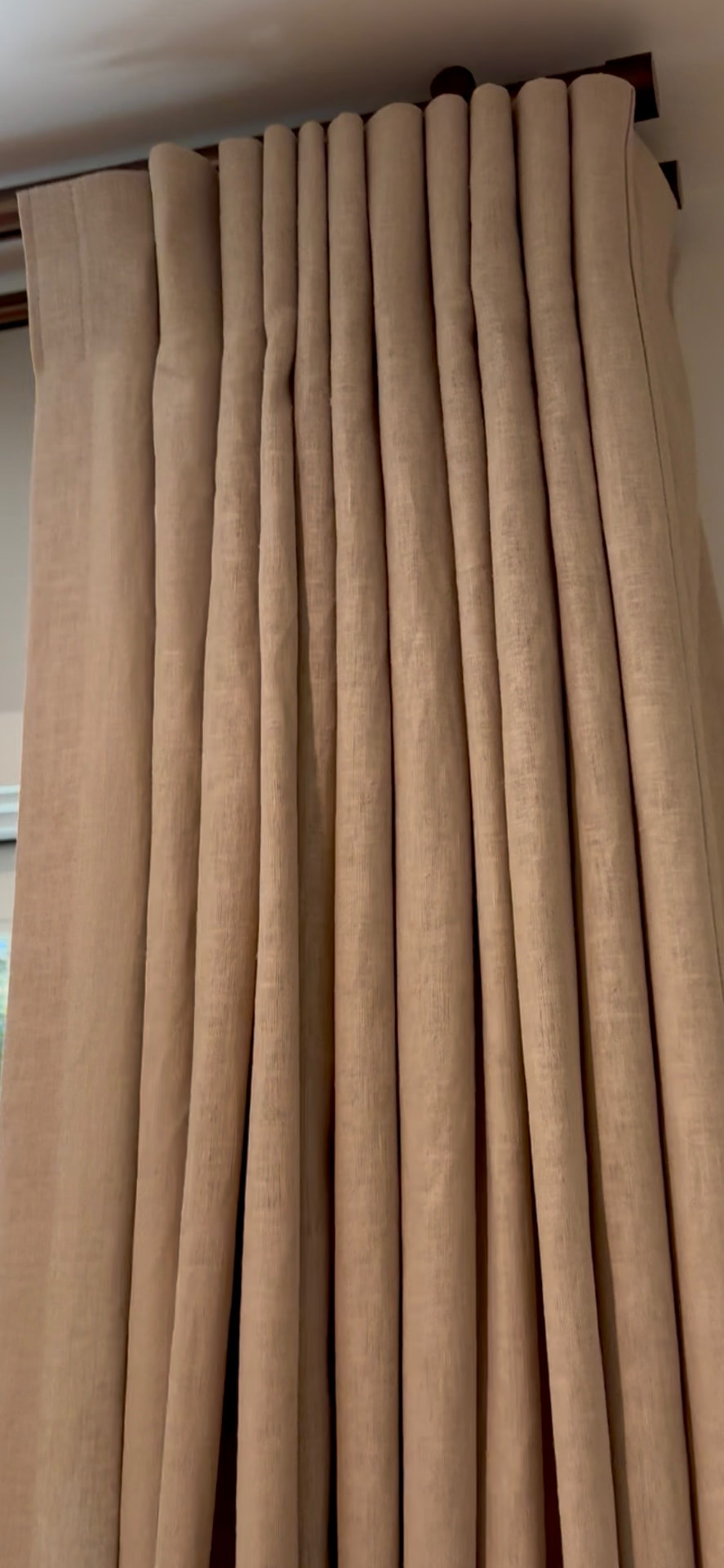 Inverted pleat linen drapery with bronze hybrid rod track hardware