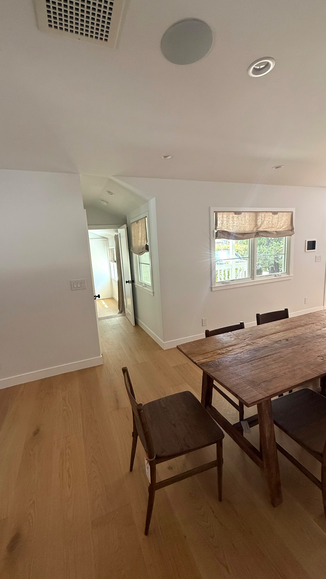 Neutral linen Roman shade in Venice Beach dining area