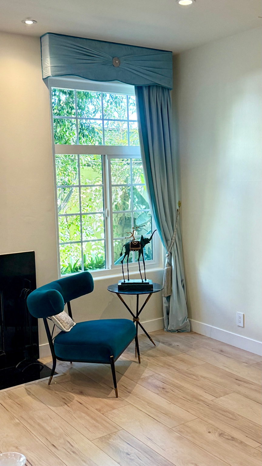 Right powder blue velvet drapery treatment beside fireplace in Beverly Hills condominium