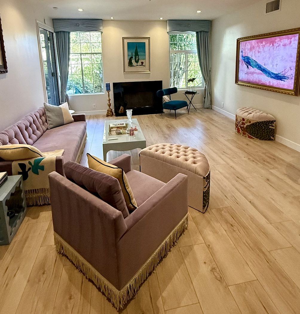 Matching powder blue velvet drapery treatments flanking fireplace in Beverly Hills condominium